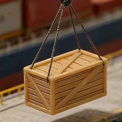A miniature model port scene with toy cargo crates, a small ship, crane, dockworkers, and a shipper on a white studio background.
