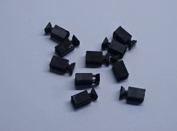 Ten black NEM coupling pockets for compatible Hornby, Bachmann and Heljan model railway rolling stock